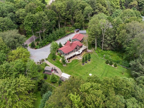 An image featuring building, plant, property, tree, natural landscape, land lot, house, urban design, cottage, landscape at 276 Mountain View Ln.