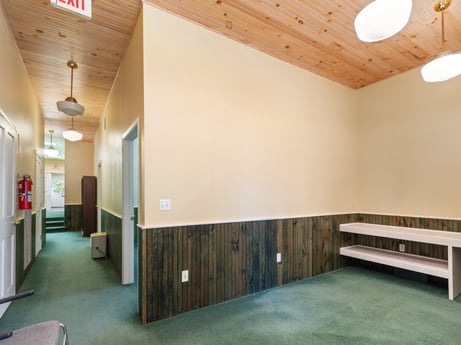 An image featuring property, wood, interior design, lighting, hall, architecture, floor, flooring, building, wall at 213 Main St.