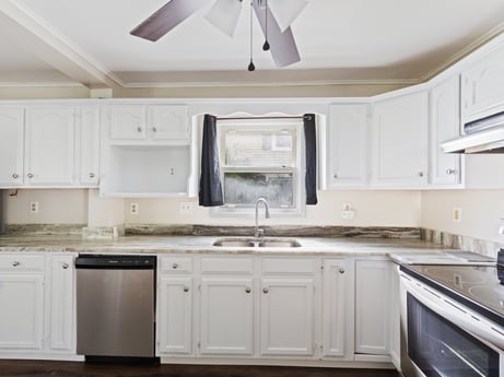 An image featuring cabinetry, countertop, property, ceiling fan, building, white, kitchen sink, sink, wood, lighting at 203 Harrison St.