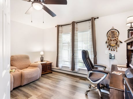 An image featuring furniture, ceiling fan, picture frame, wood, comfort, floor, chair, living room, flooring, hardwood at 105 Thomas St.
