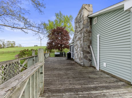 An image featuring sky, plant, property, building, cloud, tree, wood, road surface, fence, grass at 1195 Twin Cuts Rd.