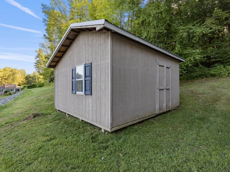 An image featuring building, plant, window, door, sky, tree, wood, house, land lot, cloud at 127 Shore Dr.