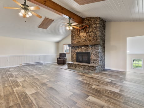 An image featuring wood, hall, ceiling fan, flooring, floor, living room, hardwood, wood stain, building material, real estate at 1195 Twin Cuts Rd.