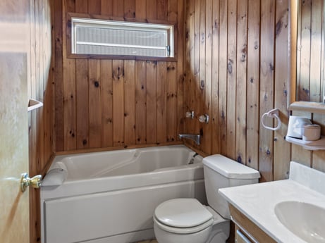 An image featuring plumbing fixture, property, bathtub, tap, bathroom, sink, wood, fixture, house, floor at 815 Lakeside Dr.