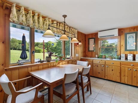 An image featuring table, property, furniture, cabinetry, plant, wood, interior design, countertop, window, lighting at 130 Haighs Pond Rd.