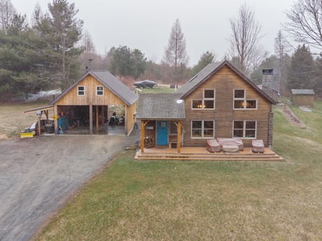 An image featuring property, window, plant, sky, tree, building, wood, land lot, house, cottage at 144 Milton Ln.