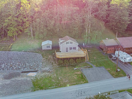 An image featuring plant, building, house, window, land lot, tree, grass, natural landscape, cottage, landscape at 127 Shore Dr.