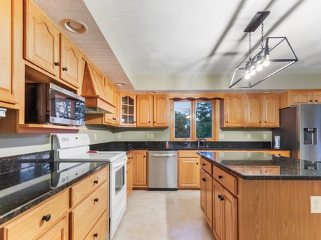 A kitchen at 74 Susquehannock Trail featuring: countertop, cabinetry, furniture, drawer, wood, kitchen, kitchen appliance, building, interior design, kitchen stove