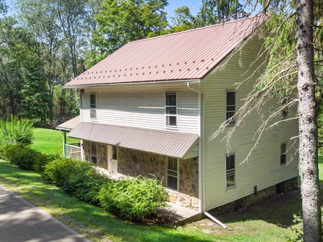 An image featuring plant, building, window, property, house, tree, wood, cottage, roof, grass at 1039 Old Bernice Rd.