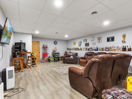 An image featuring furniture, couch, building, floor, flooring, living room, wood, studio couch, comfort, table at 17899 US-6.