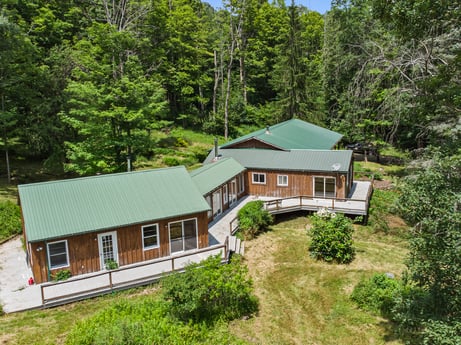 An image featuring plant, window, building, tree, house, natural landscape, land lot, wood, cottage, grass at 154 Fox Run Rd.