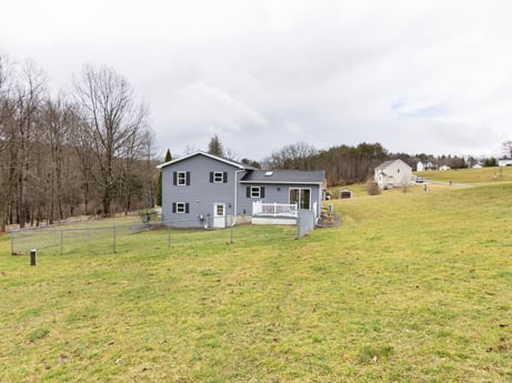 An image featuring sky, cloud, plant, window, building, land lot, natural landscape, house, tree, grass at 18 Country View Dr.