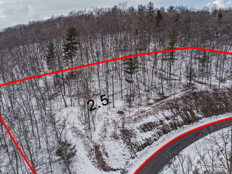 An image featuring sky, snow, mountain, infrastructure, tree, slope, cloud, mountainous landforms, road, landscape at Hemlock Hill Rd.