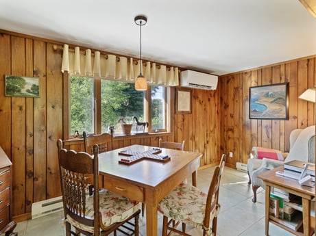 A kitchen at 130 Haighs Pond Rd featuring: table, furniture, countertop, cabinetry, chair, window, kitchen, wood, interior design, kitchen & dining room table