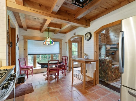 An image featuring furniture, table, chair, wood, building, interior design, plant, floor, living room, flooring at 1761 Brick House Rd.