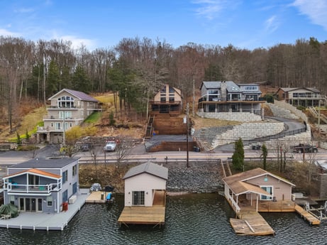 An image featuring cloud, sky, building, window, plant, tree, house, urban design, neighbourhood, residential area at 815 Lakeside Dr.