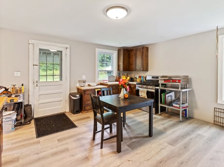 A kitchen at 2399 Keene Summit Rd featuring: table, furniture, window, couch, building, wood, kitchen, chair, flooring, living room
