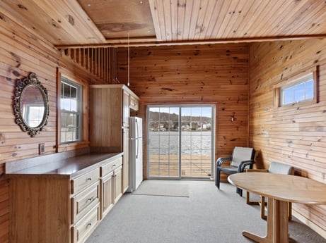An image featuring furniture, building, window, table, wood, cabinetry, wood stain, beam, mirror, flooring at 815 Lakeside Dr.