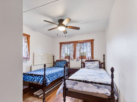 An image featuring furniture, property, window, ceiling fan, building, comfort, wood, bed frame, bed, lighting at 103 Mokoma Ave.
