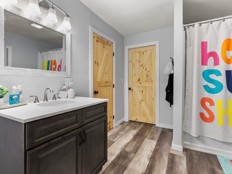 An image featuring mirror, cabinetry, sink, property, bathroom cabinet, white, tap, countertop, interior design, plumbing fixture at 17899 US-6.