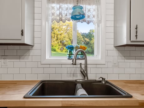 A kitchen at 491 Hillcrest Dr featuring: kitchen sink, sink, tap, blue, countertop, plumbing fixture, window, interior design, wood, kitchen