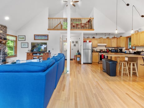 An image featuring furniture, couch, table, wood, shelf, interior design, home appliance, floor, chair, ceiling fan at 459 Pine Hill Dr.