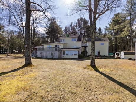 An image featuring sky, plant, building, cloud, tree, land lot, house, neighbourhood, residential area, road surface at 199 S Lake Rd.