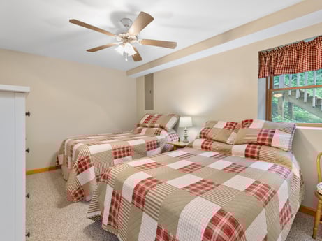 An image featuring furniture, window, ceiling fan, building, window blind, comfort, wood, bed skirt, textile, interior design at 459 Pine Hill Dr.