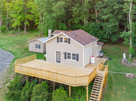 An image featuring plant, window, building, tree, house, wood, land lot, cottage, siding, grass at 127 Shore Dr.