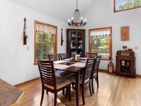 An image featuring table, property, furniture, picture frame, chair, wood, lighting, cabinetry, interior design, floor at 459 Pine Hill Dr.