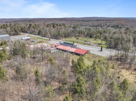 An image featuring sky, plant, cloud, tree, land lot, natural landscape, house, plain, landscape, grass at 4741 US-220.