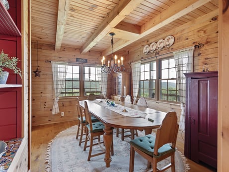 An image featuring table, property, furniture, chair, wood, interior design, lighting, floor, wood stain, beam at 1761 Brick House Rd.