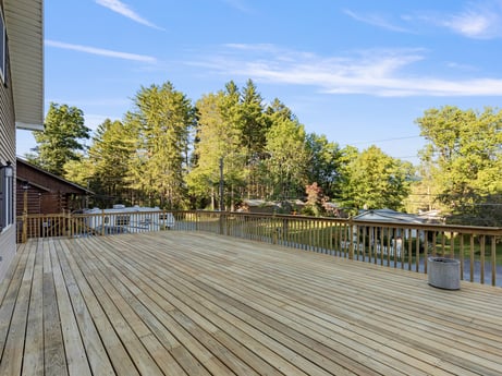 An image featuring cloud, sky, tree, wood, shade, leisure, urban design, landscape, road surface, roof at 127 Shore Dr.