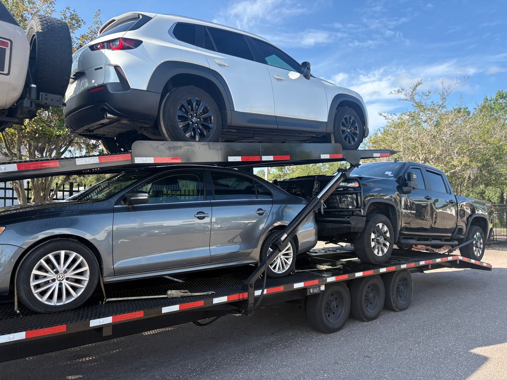 Two-level Texas Pride car hauler loaded with an SUV, a sedan and a Silverado pickup