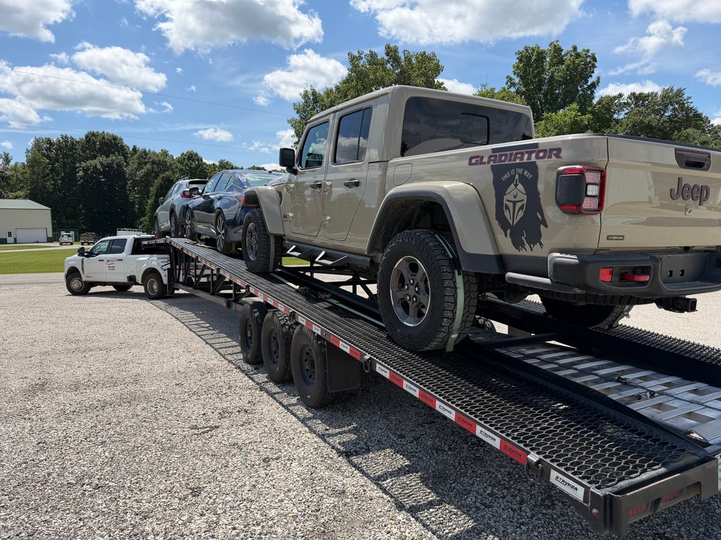 Jeep Gladiator strapped down on the rear deck of a Velocity Logistics wedge carrier