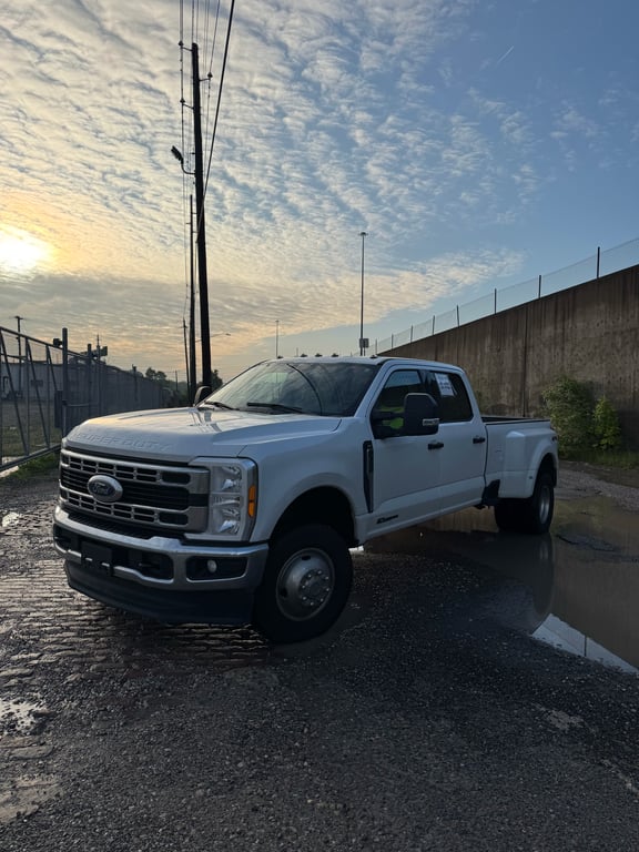 2023 Ford F-350 dually towing a loaded wedge carrier