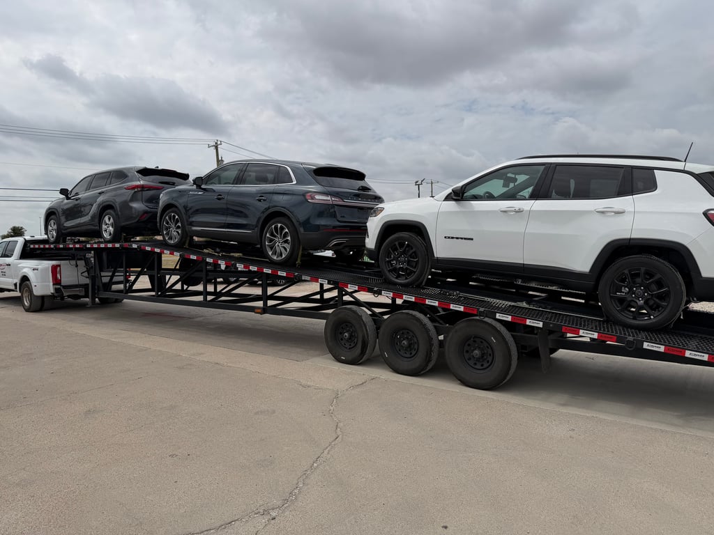 Velocity Logistics wedge carrier loaded with three dealer SUVs