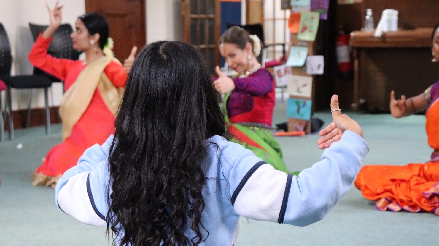 Children and adults taking part in a Kathak dance workshop