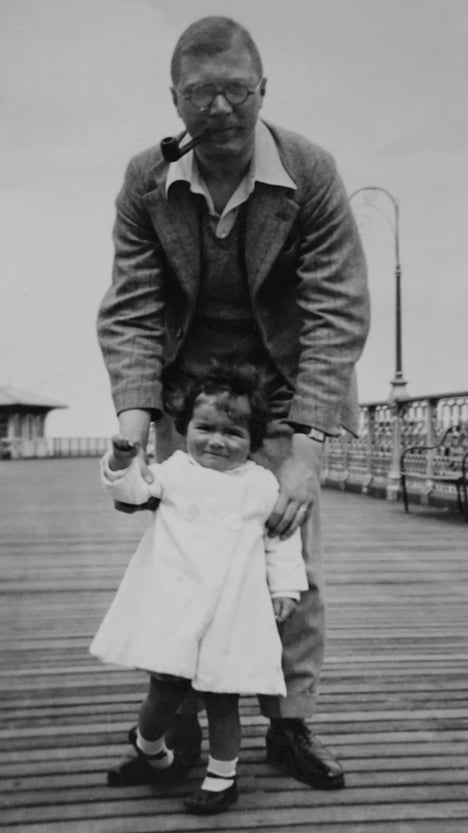 Image of a man standing with a small child