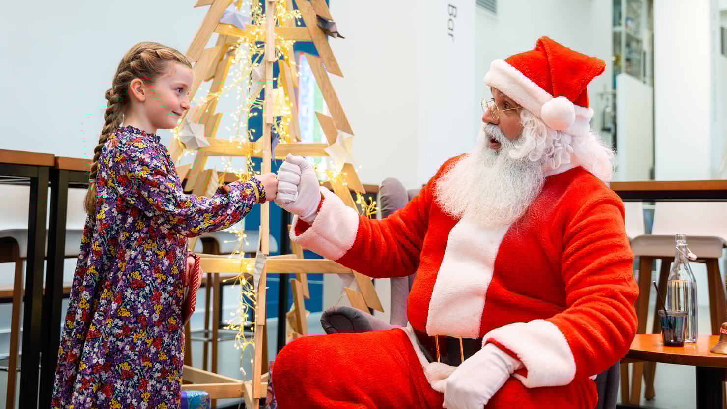 Father Christmas talks to a young girl at The Box Plymouth