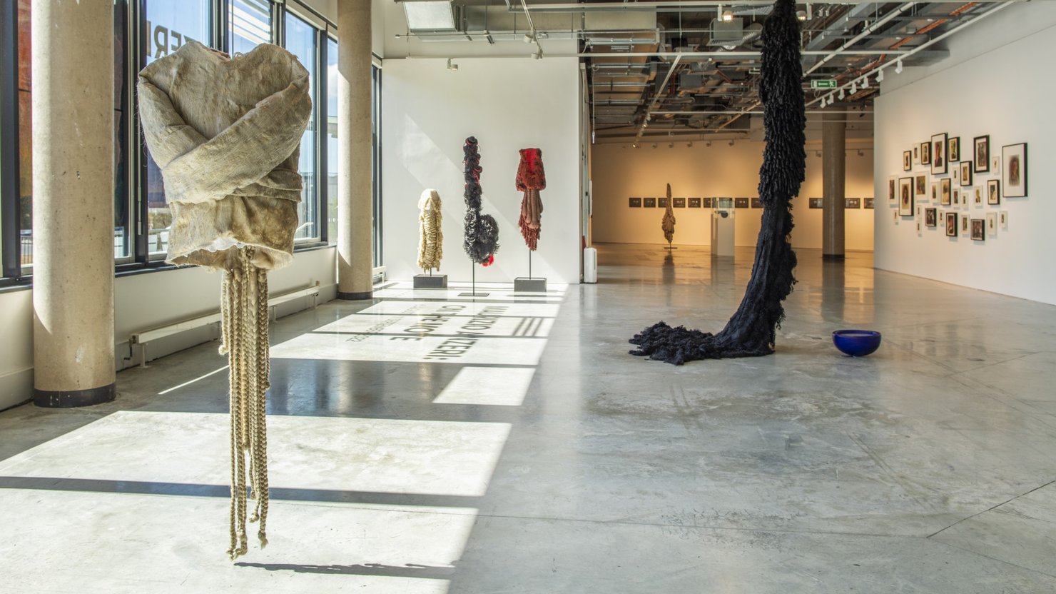 Image showing a view of an exhibition that has a mix of 2D and 3D artwork within the space.