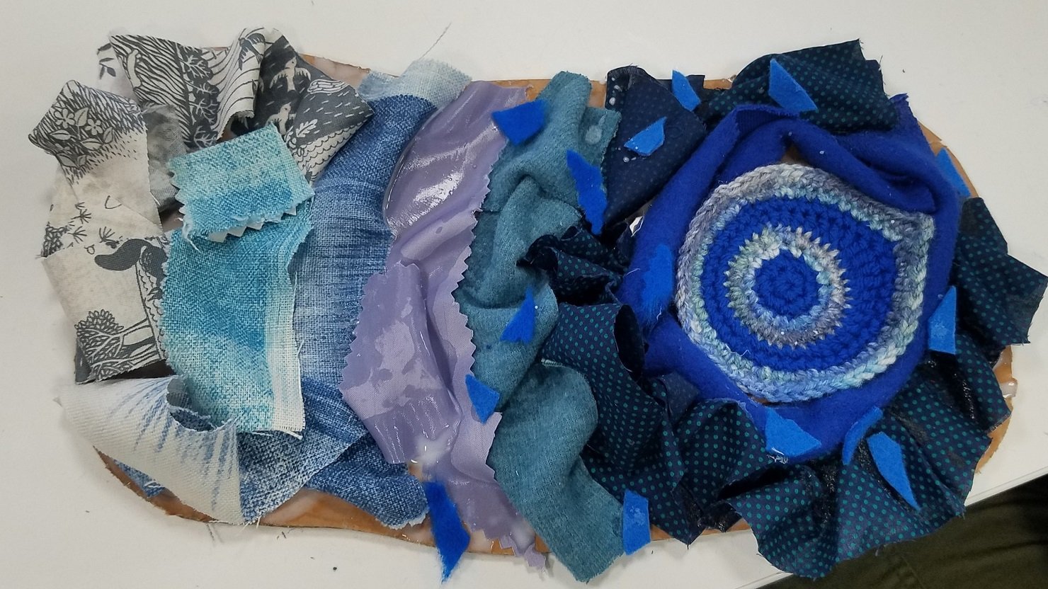 A 'crafty puddle' made from scraps of blue fabric