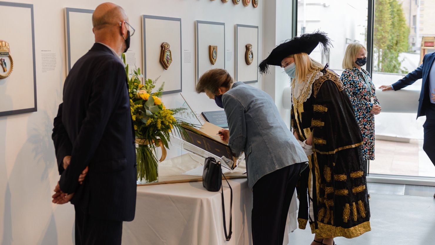 HRH The Princess Royal signing a book at The Box