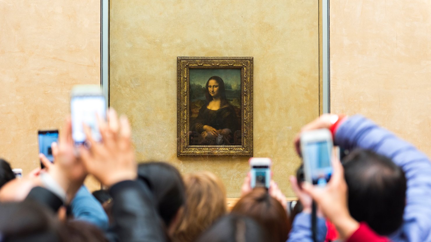 The Mona Lisa being photographed by visitors at the Louvre in 2017