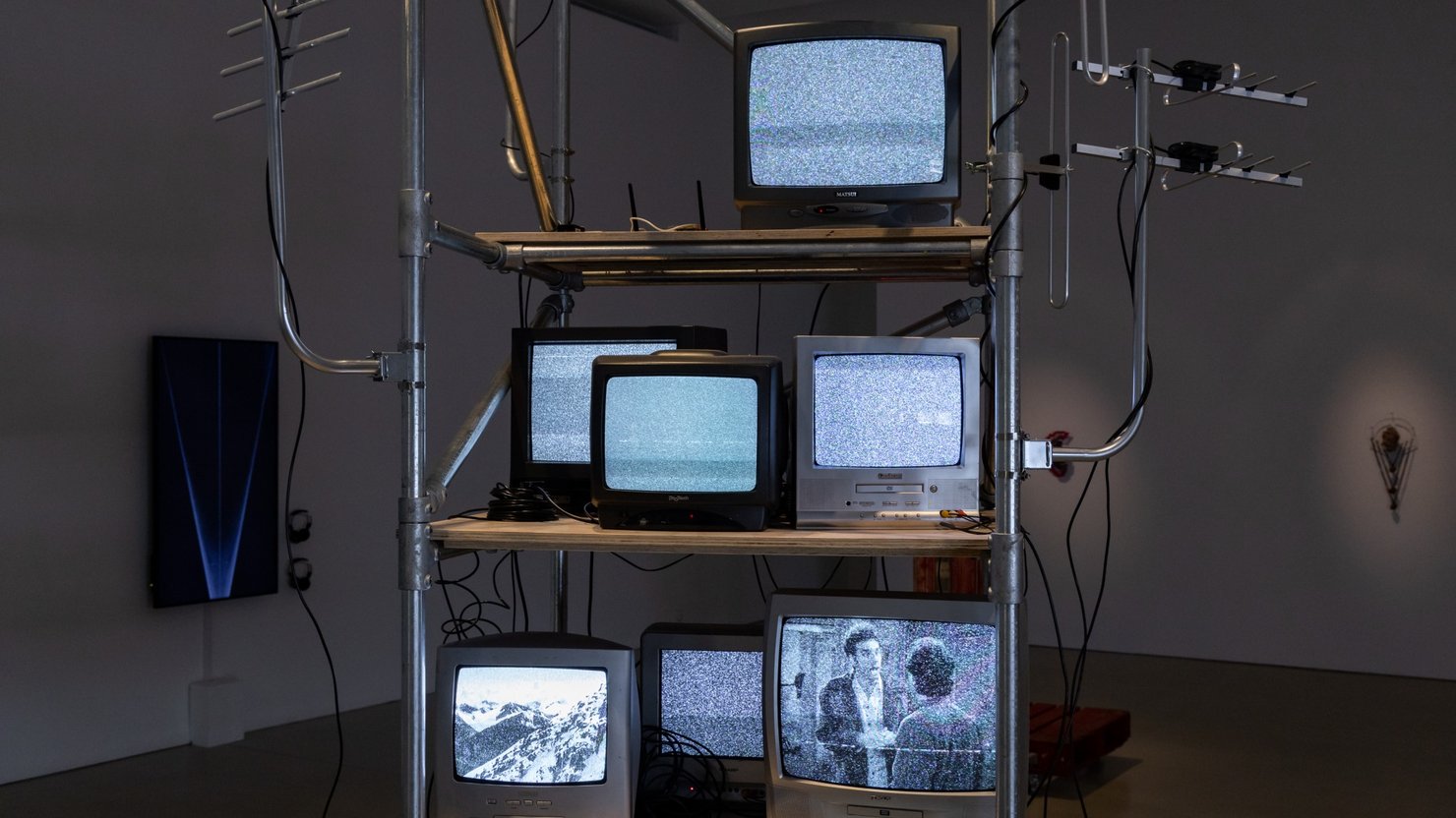 Photograph showing an installation of an artwork using television sets on a display unit