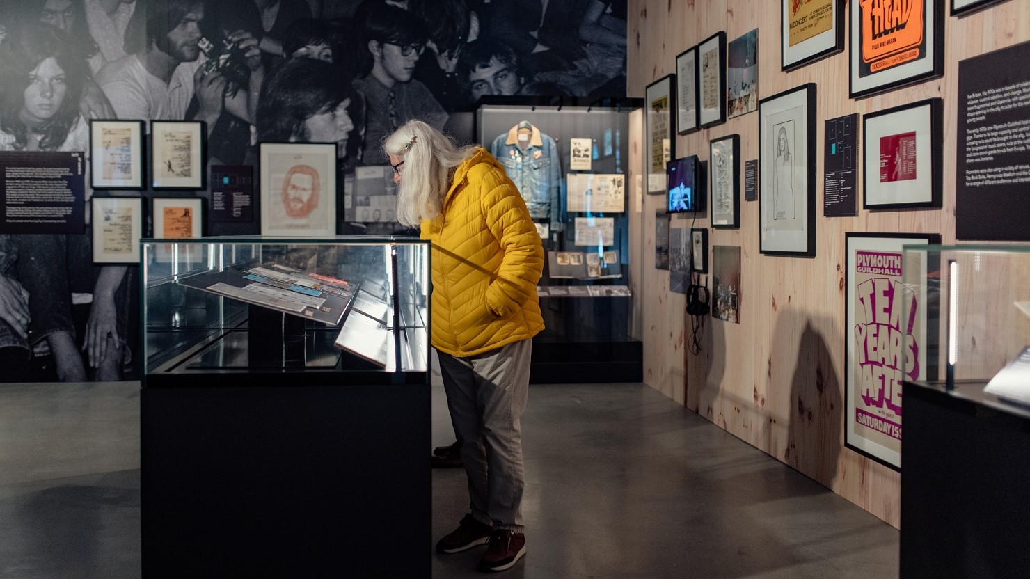 A visitor looking at the 'because the night belongs to us' exhibition