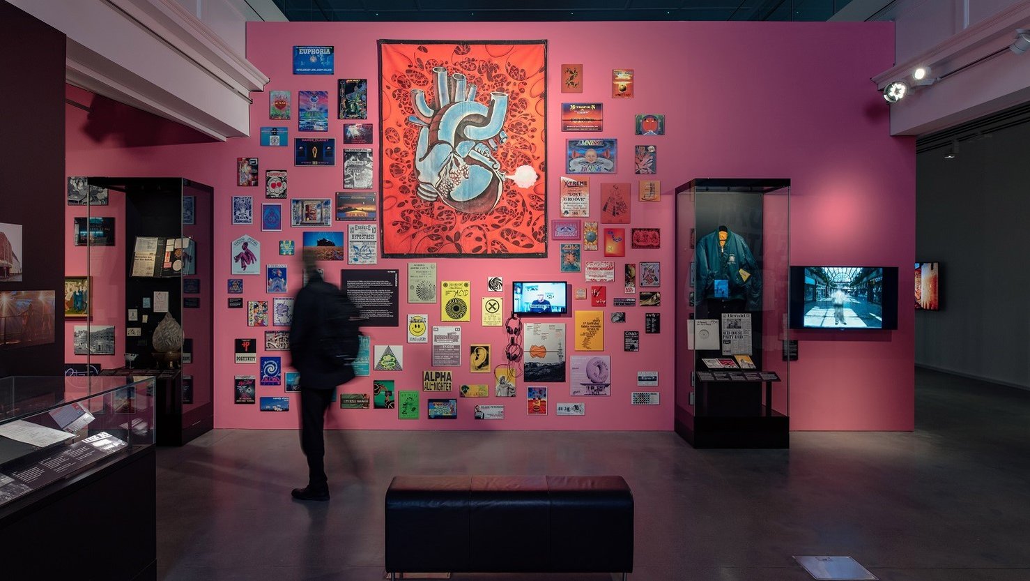 A visitor looking at the 'because the night belongs to us' exhibition