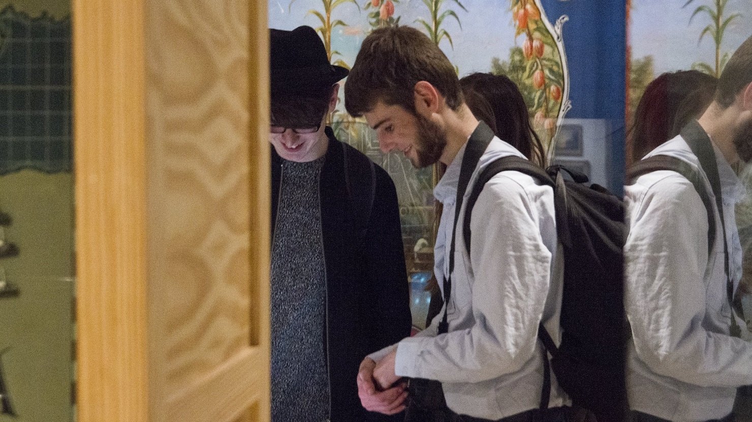 Two men looking at an art exhibition in a gallery