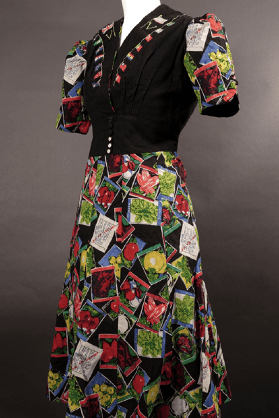 Photograph showing a dress with black bodice and brightly coloured skirt on a mannequin