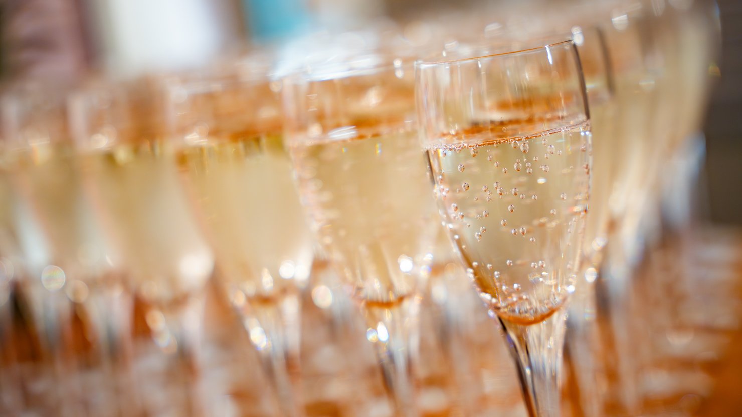 A number of filled champagne flutes